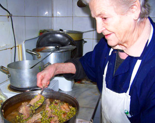 Ada prepares to serve boiled veal with spinach and peas