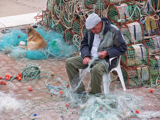 Fisherman mending his nets, Cascais, Portugal